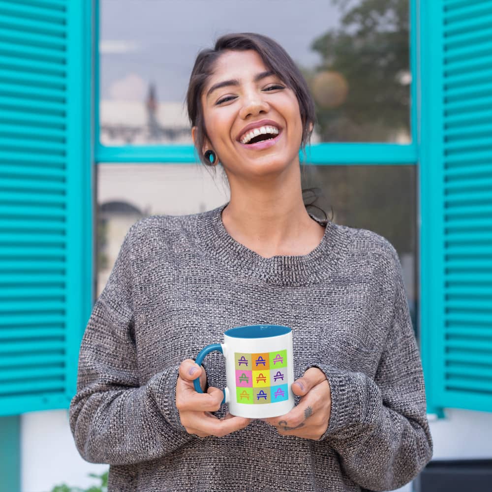 a woman holding an AMP Swagg pop art mug in blue