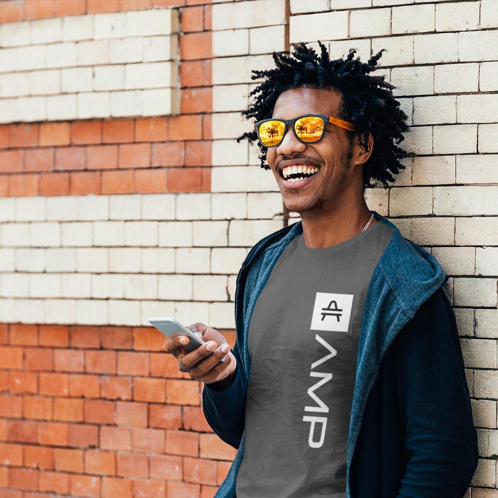 Guy in front of a wall wearing an Asphalt AMP Token Amp Swagg Lambda Shirt