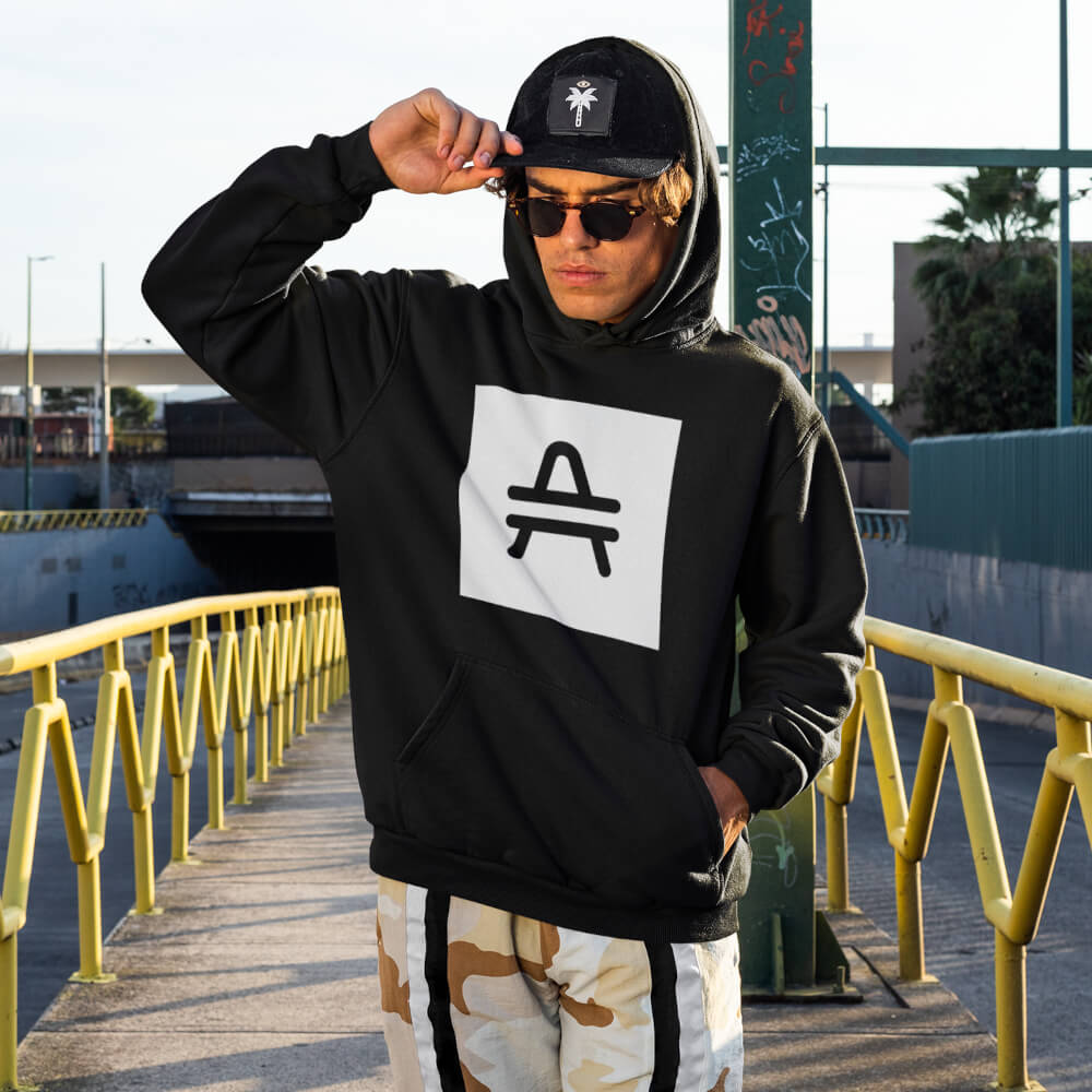 a man wearing a black AMP token AMP swagg alt-logo hoodie