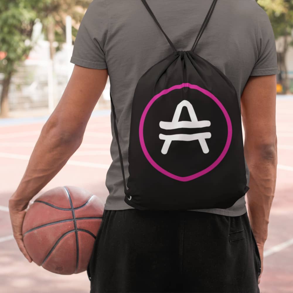 Man wearing a black AMP Token AMP Swagg Drawstring bag with a stenciled AMP Token Logo
