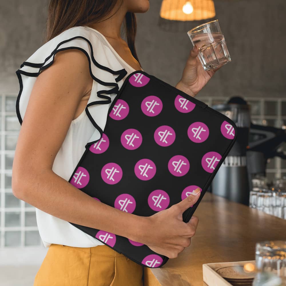 A woman holding a black AMP Token AMP Swagg Laptop Sleeve