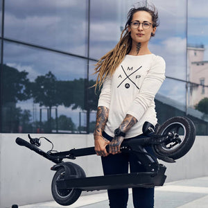 a woman with a scooter wearing an amp swagg amp-x long sleeve in white