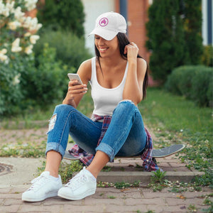 Woman wearing a white AMP Token AMP Swagg alt-logo cap