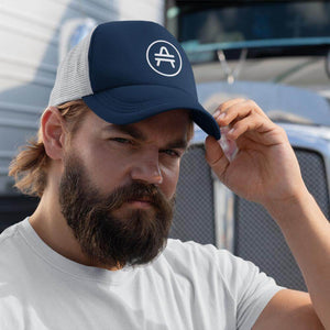 A guy wearing a navy AMP Token AMP swagg alt-logo Trucker hat