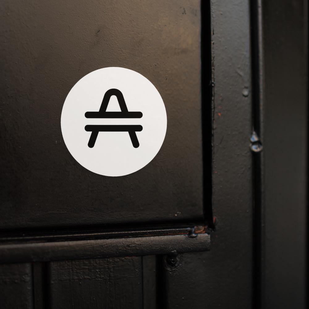 AMP Token Solid Alt-logo Sticker in large placed on a black door