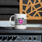 AMP Token White Mug #WE-ARE 11oz in white sitting on a stereo speaker