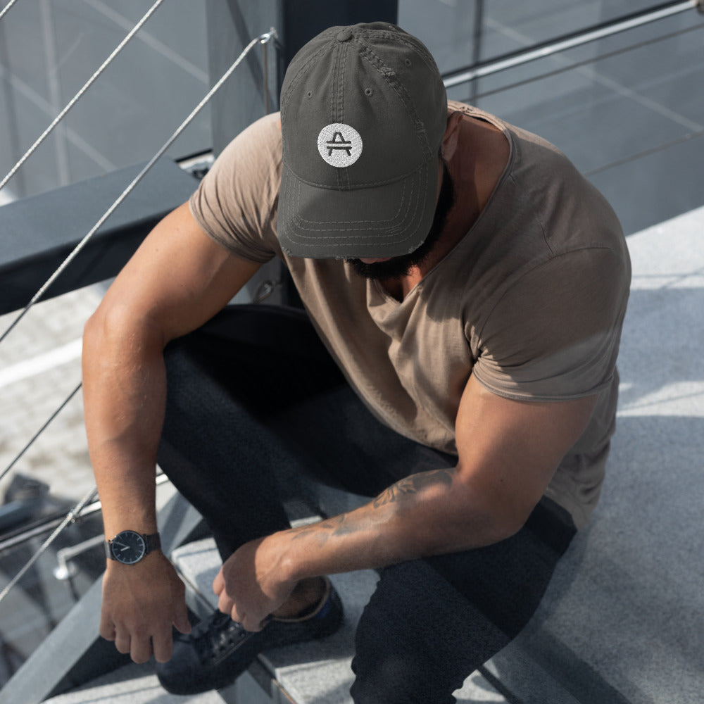AMP Token Solid Alt-logo Distressed Hat in grey worn by a man