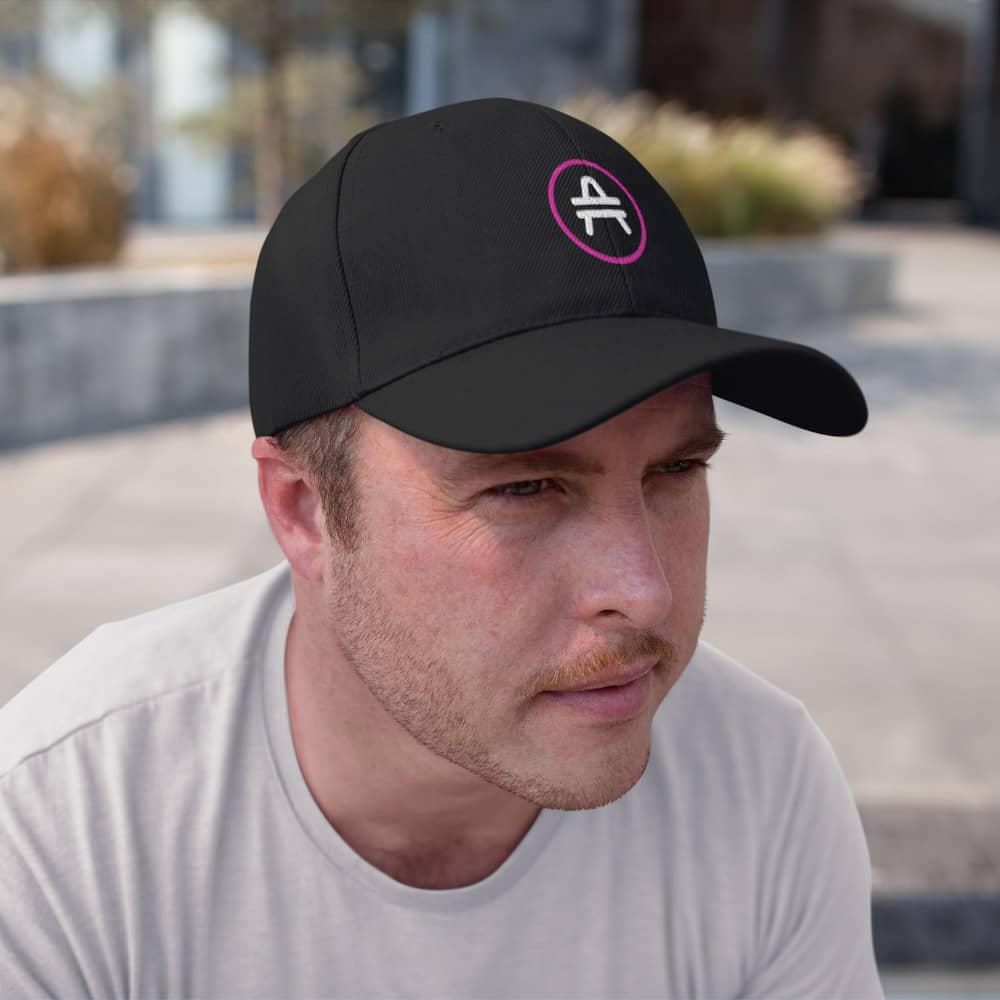 AMP Token Stenciled Alt-logo Flexfit Hat in black worn by a man