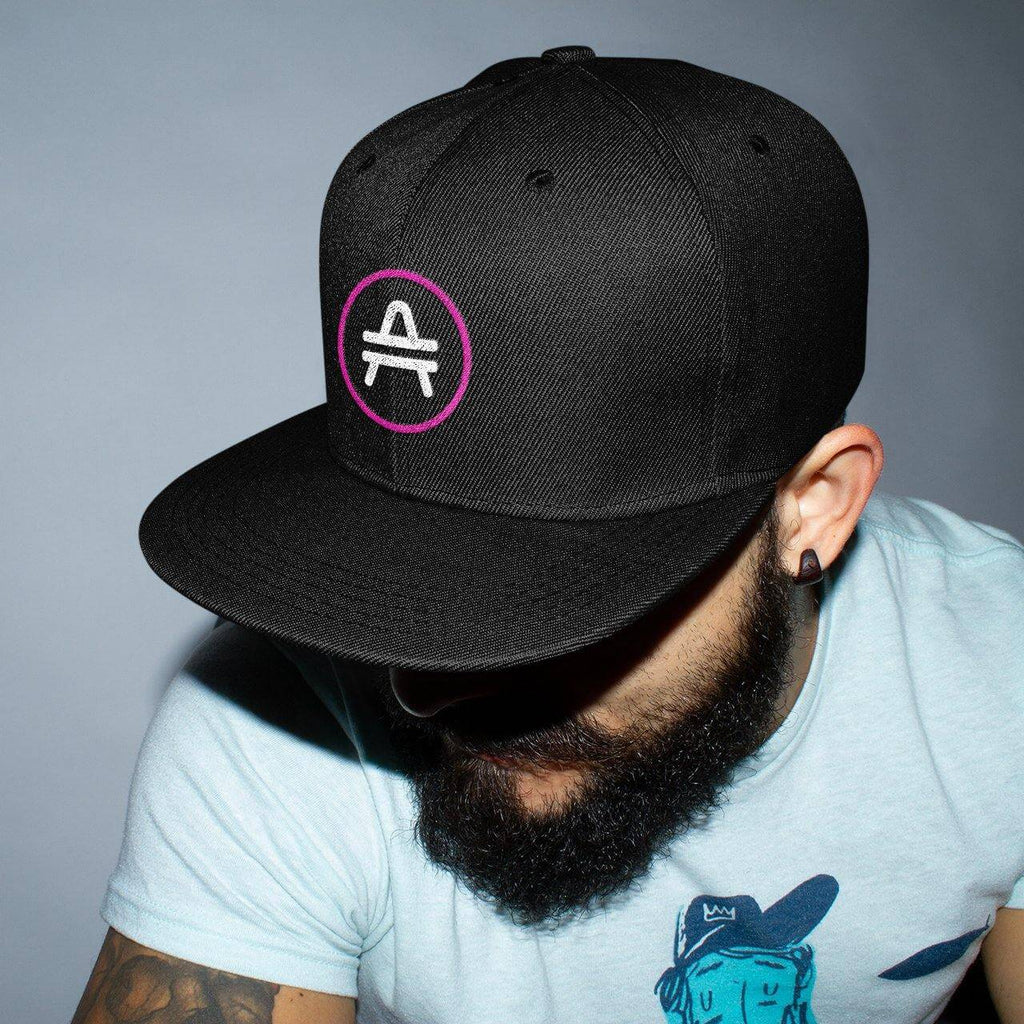 Bearded man wearing a black AMP Token AMP swagg snapback hat