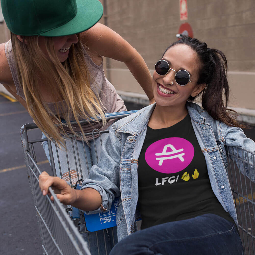 Two girls having fun and one wearing an AMP token AMP swagg LFG shirt in Black